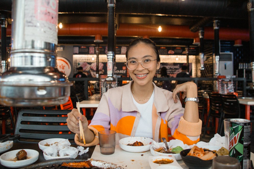 Diner enjoying and smiling while enjoying food at a restaurant table
